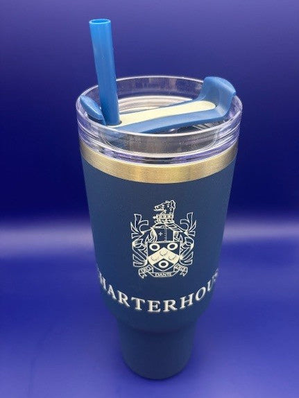 Blue tumbler with a straw on a blue background